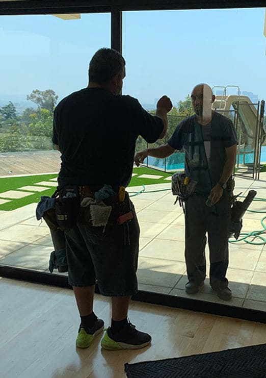 Two technicians discussing a glass cleaning job